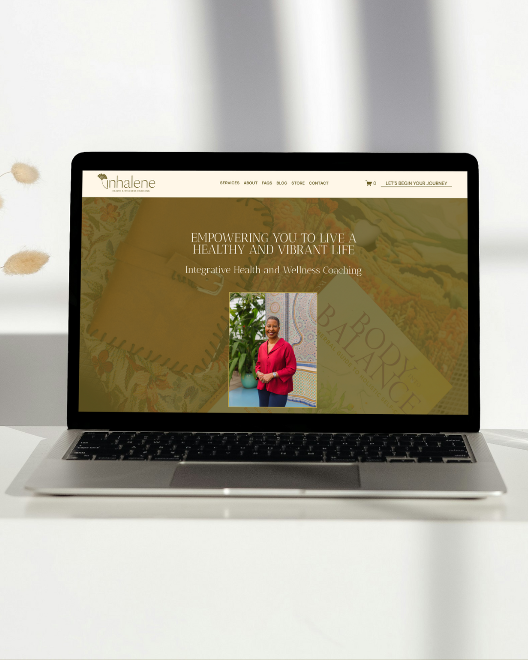 a laptop displaying the website for Inhalene Health and Wellness Coaching 