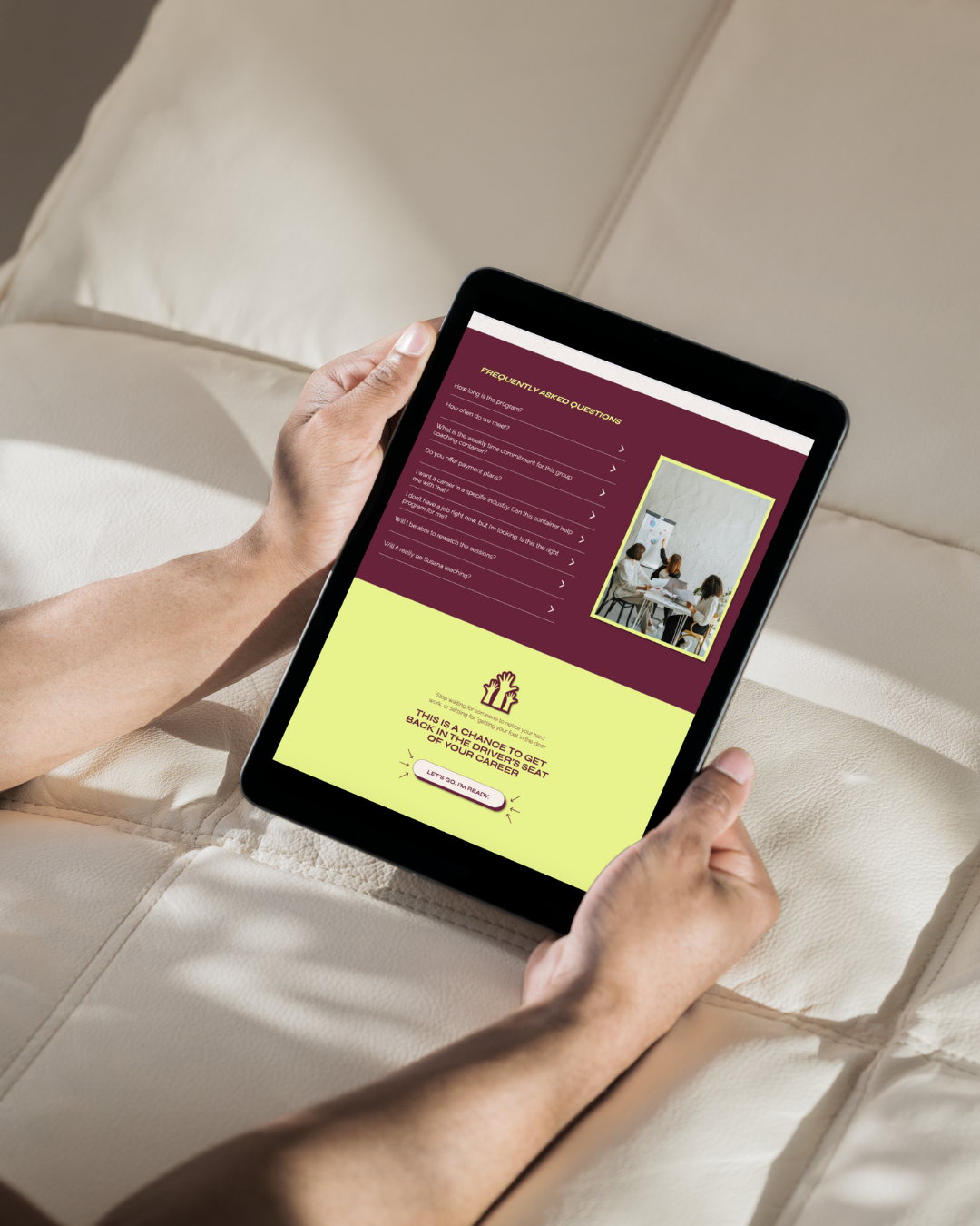 a woman on a couch holding a tablet on the tablet the woman is viewing the website for Dunamis Coaching and Consulting 