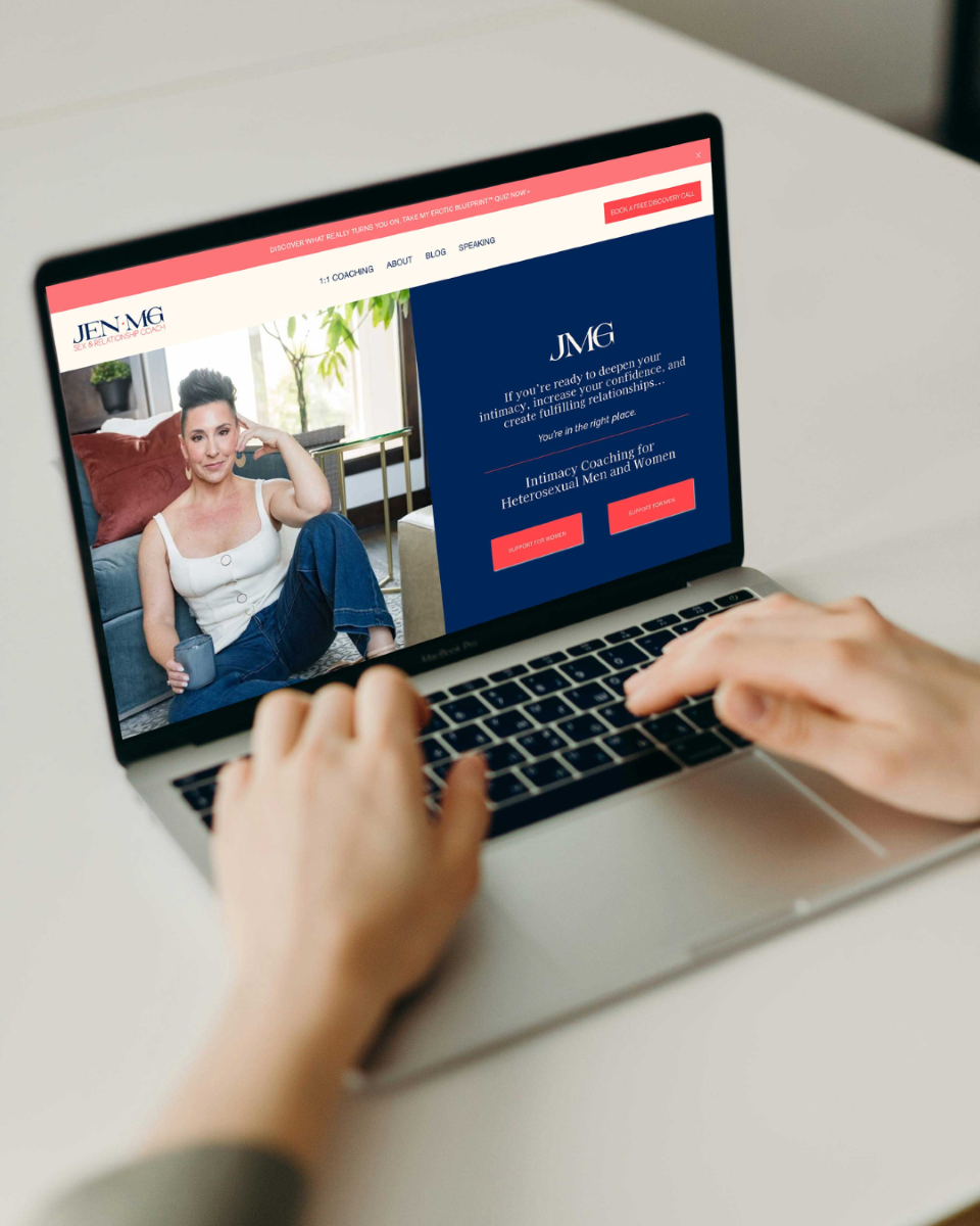 a woman with her hands on a laptop looking at the website for jen mg - a sex and relationship coach
