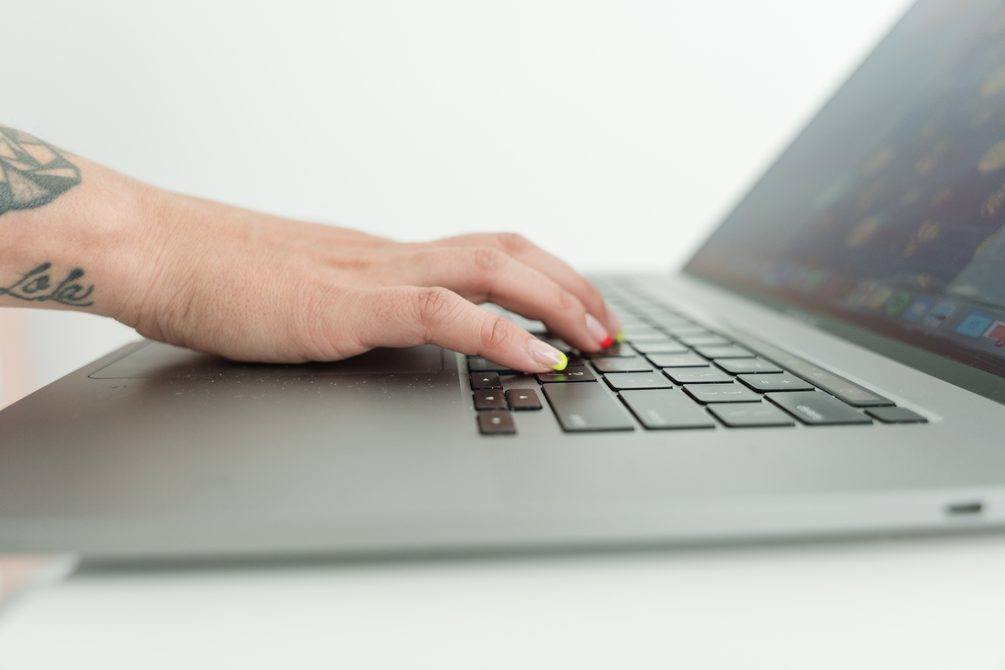 a woman typing on her laptop