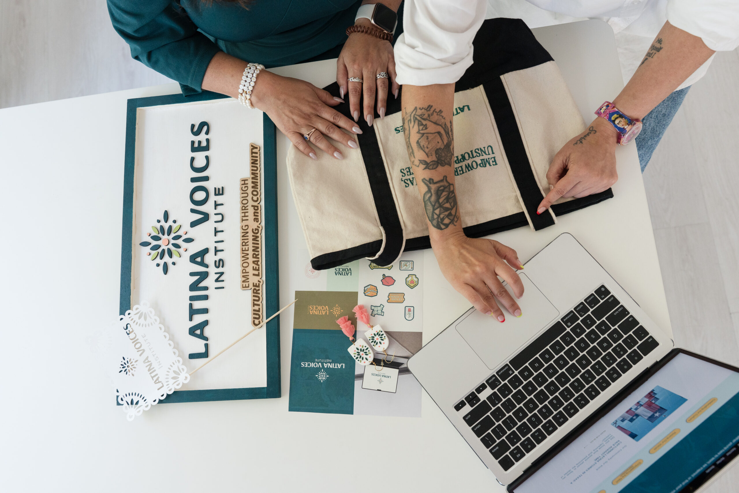 brand designer collaborating on creative strategy with laptop moodboard and brand materials
